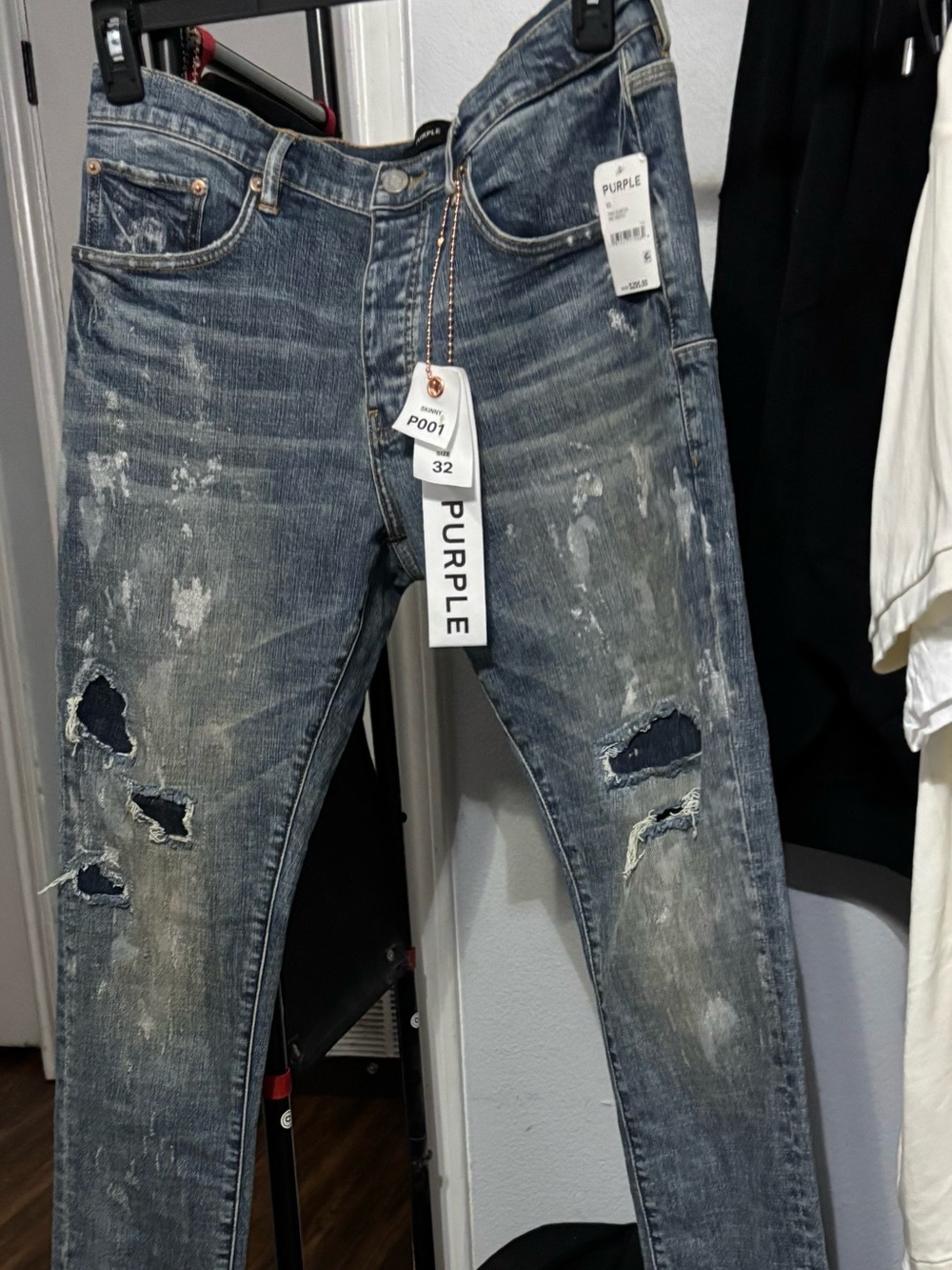 These are Purple Brand P001 low-rise skinny jeans in a light indigo wash with